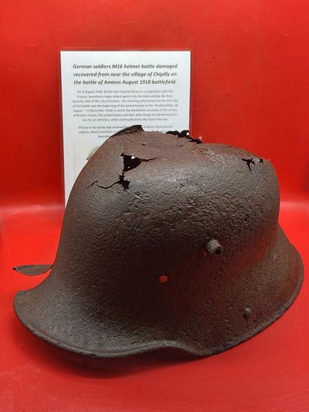 German soldiers M16 helmet battle damaged solid relic with paintwork remains recovered from near the village of Chipilly on the battle of Amiens August 1918 battlefield.