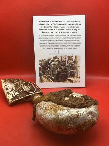 German waterbottle dated 1935 with remains of its cloth cover and drinking cup recovered in village of Marinovka, defended by the 297th Infantry Division, the battle of 1942-1943 at Stalingrad