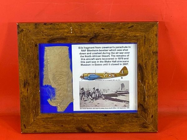 Glass framed silk fragment from crewman's parachute from RAF Blenheim bomber shot down and crashed in North Africa during the battle 1940-1943