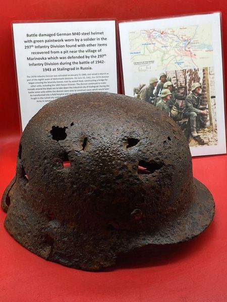 German M40 steel helmet battledamaged, lots of original green paintwork remains worn by a soldier of the 297th Infantry Division recovered from a pit in the village of Marinovka, defended by them during the battle of 1942-1943 at Stalingrad