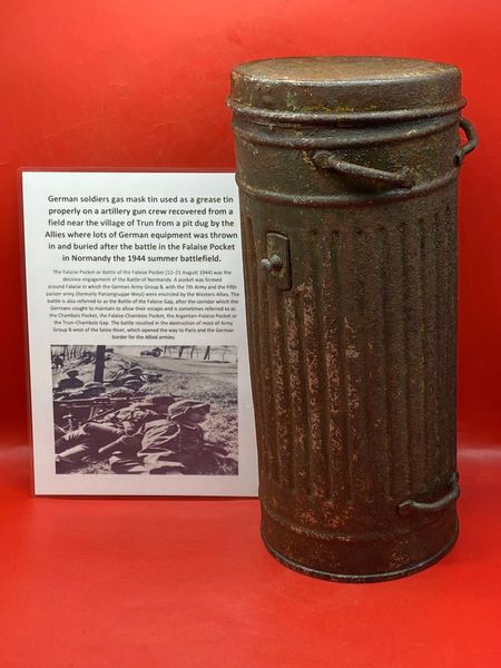 German soldiers gas mask tin used as artillery gun crew grease tin with original green paintwork remains recovered from a field near Trun a pit dug by the allies where lots of German equipment buried after the battle in the Falaise Pocket, Normandy 1944