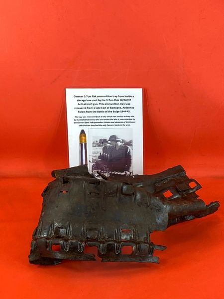 Battle damaged German 3.7cm Flak 18/36/37 anti-aircraft gun ammunition tray,solid relic condition it was recovered from a lake East of Bastogne in the Ardennes Forest from the Battle of the Bulge in the winter of 1944-45.