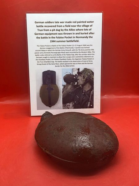 German army issue red painted water bottle, nice relic lots of original paintwork recovered from a field near Trun a pit dug by the allies where lots of German equipment buried after the battle in the Falaise Pocket, Normandy in France 1944