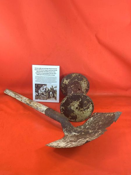 Large German trench digging shovel and telephone cable reel both in relic as found condition recovered from an old German dugout around the battlefield at Passchendaele from the 1917 battle part of the third battle of Ypres.