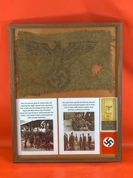 Glass framed Part of a German grain or rations sack, still retaining the ‘Eagle’ stamp it was recovered from a field near the village of Trun from a pit where lots of German equipment found after the battle in the Falaise Pocket in Normandy,1944