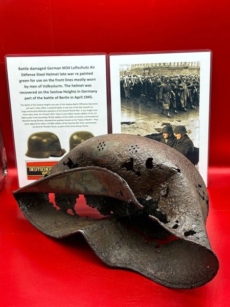 Rare Battle damaged German M34 Luftschutz Air Défense Steel Helmet late war re painted green for use on the front lines mostly worn by men of Volkssturm,recovered on the Seelow Heights in Germany part of the battle of Berlin in April 1945.