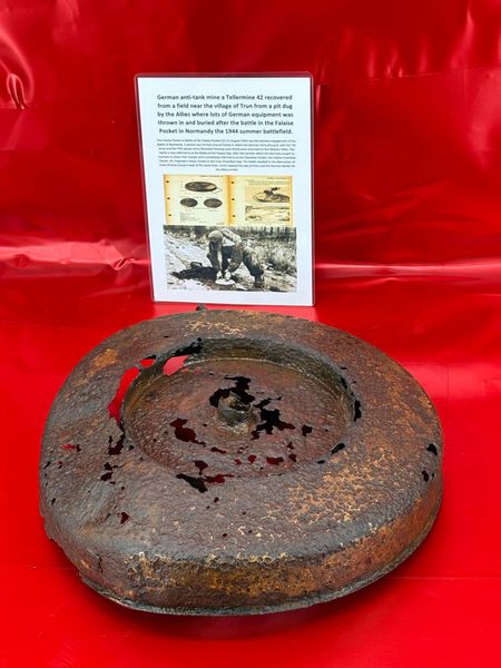 German anti-tank mine a Tellermine 42 with lots of original sand colour paintwork recovered from a field near Trun a pit dug by the allies where lots of German equipment buried after the battle in the Falaise Pocket, Normandy in France 1944