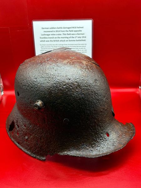 German M16 helmet battle damaged solid relic condition recovered in 2014 from the old German trench line at La Boisselle in the field opposite where the Lochnagar mine crater on the Somme July 1916 battlefield