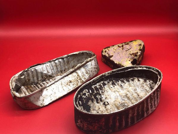 A pair of food tins and a small triangle tin with yellow stamped markings used by German soldiers of 212 Volksgrenadier-Division recovered near town of osweiler, Luxemburg from the battle of the Bulge 1944-1945