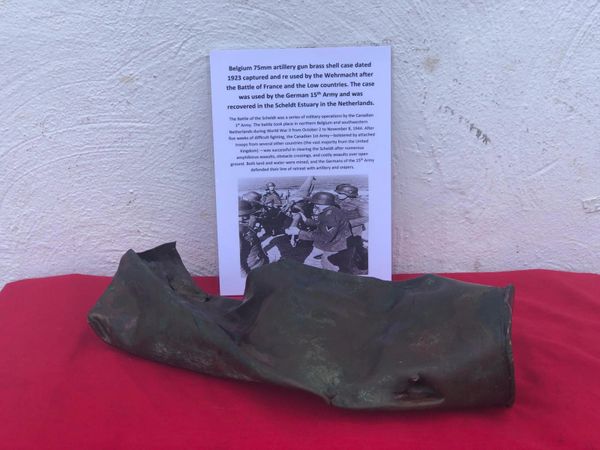 Belgium 75mm artillery gun brass shell case, battle damaged dated 1923 captured and re used by the Wehrmacht after the Battle of France and the Low countries used by the German 15th Army and was recovered in the Scheldt Estuary, Netherlands 1944 battle