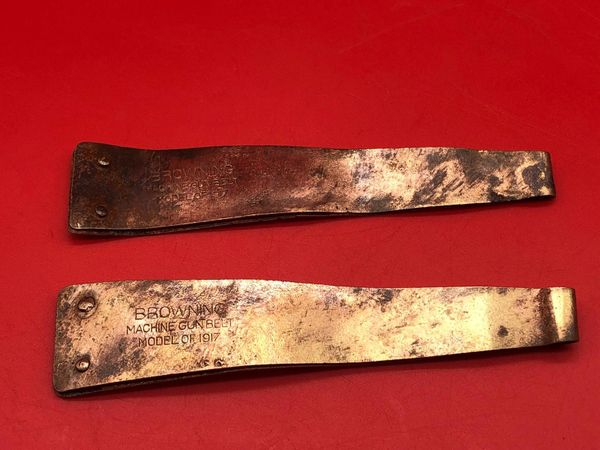 Pair of American Browning machine gun ammunition belt starter tabs very nice condition relics ,bent up, brass colour with all there original markings recovered from the Meuse Argonne Forest the 1918 battlefield