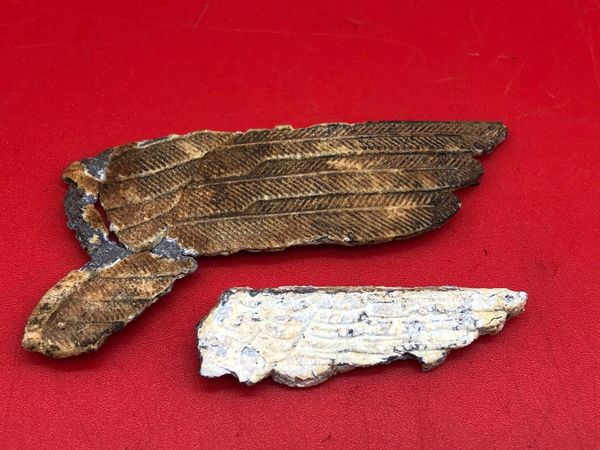 Luftwaffe and Army cap eagle wings used by German soldiers of 212 Volksgrenadier-Division recovered near town of osweiler, Luxemburg from the battle of the Bulge 1944-1945