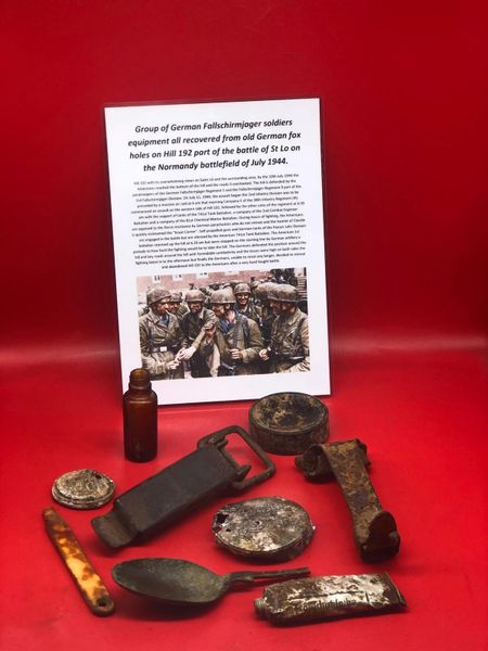 Group of soldiers equipment some with maker markings, medical and personal recovered from German Fallschirmjager soldiers fox holes on Hill 192 part of the battle of St Lo on the Normandy battlefield of July 1944