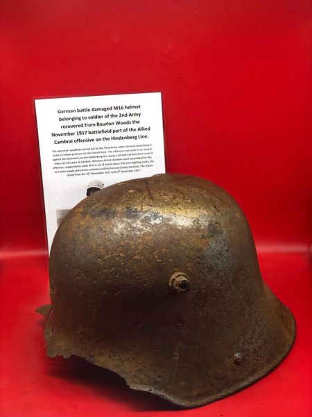 Fantastic condition German soldiers M16 battle damaged helmet lots of original paint remains has very well cleaned recovered from Bourlon Woods the November 1917 battle part of the Allied Cambrai offensive.