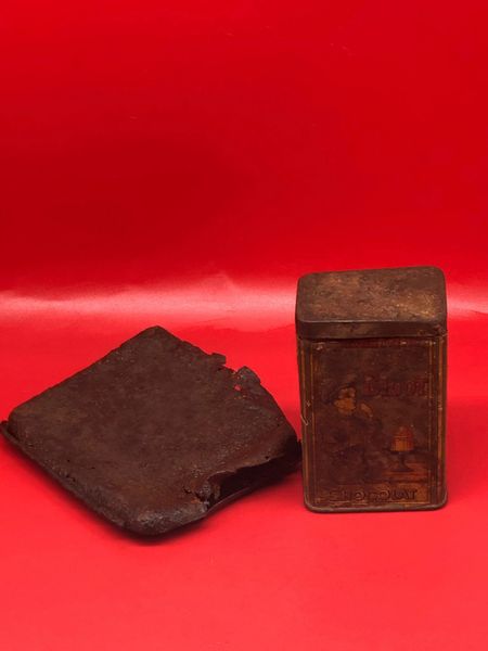 Soldiers cigarette tin and Bigot Chocolat tin with many maker markings and colour clear to see recovered from German bunker near Bucquay on the Somme battlefield 1916-1918