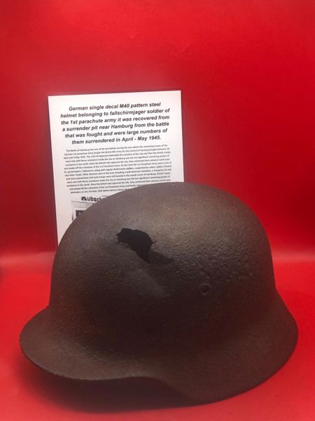 German Fallschirmjager soldier of the 1st parachute army M40 helmet with single decal remains, green paint remains, impact hit recovered near Hamburg from the battle that was fought and were large numbers of them surrendered in April - May 1945