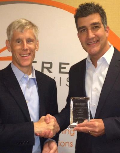 Tom Flynn receiving 2015 award for Technology Innovation by Henry Ijams of Paystream Advisors