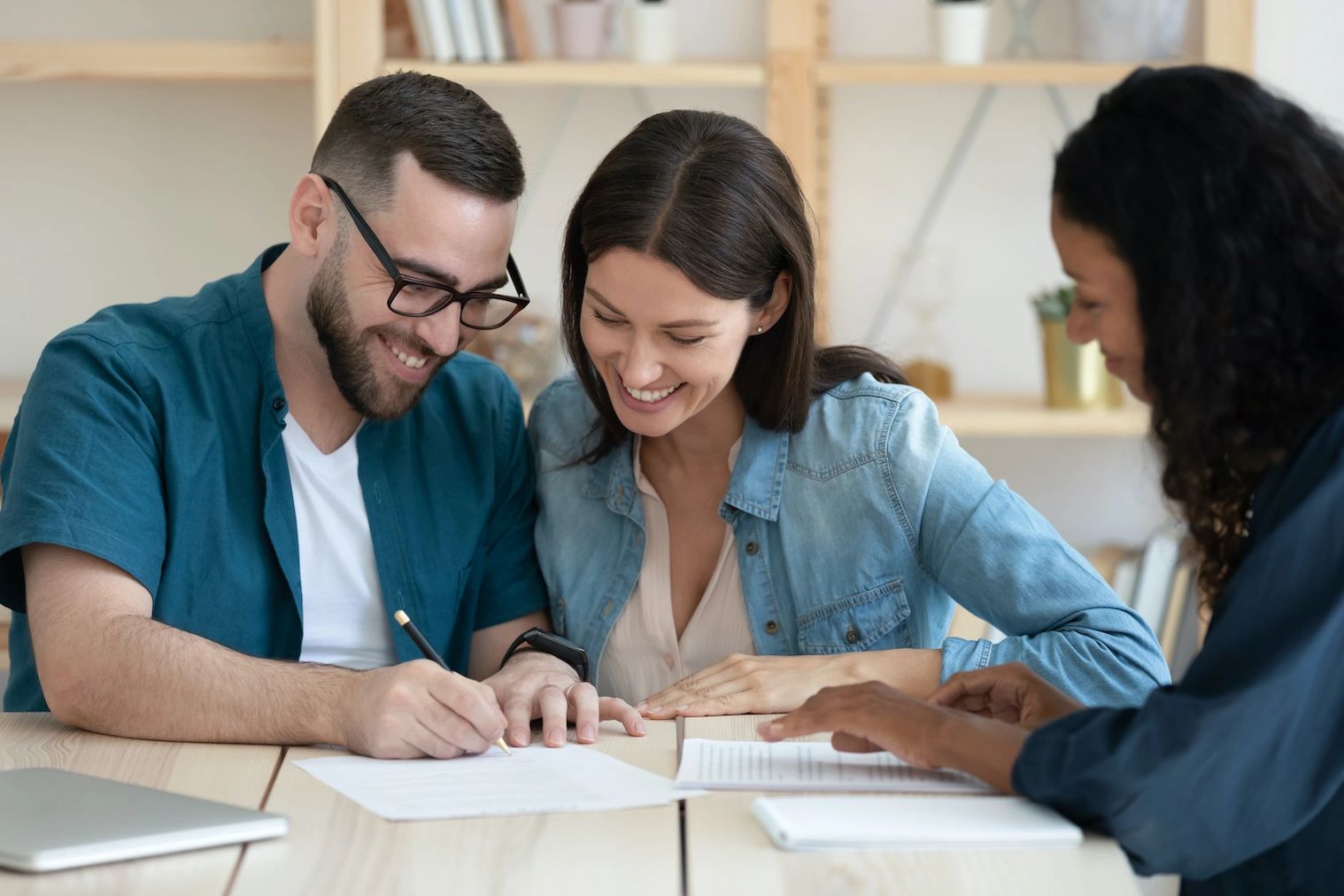 A couple signing on the document