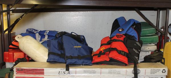 Assortment of Life Jackets and Cushions