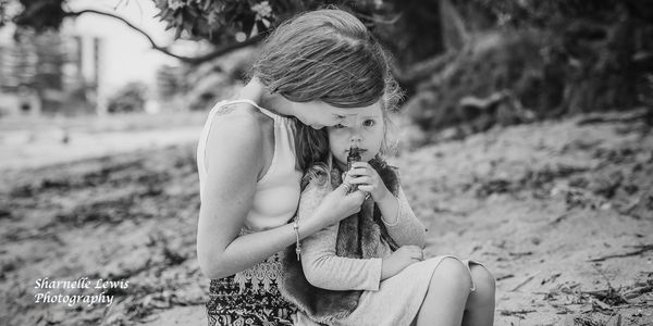 Mother with daighter sitting on her knee smelling doTERRA essential oils