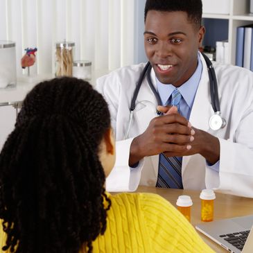 Doctor talking to patient in office.
