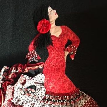 Fabric art of a flamenco dancer in a red dress.