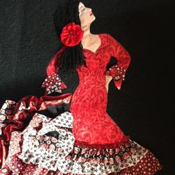 Fabric art of a flamenco dancer in a red dress.