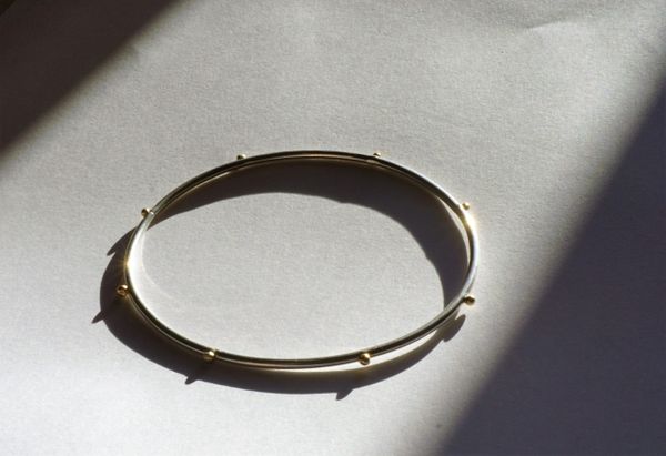 Sterling silver and solid gold bangle