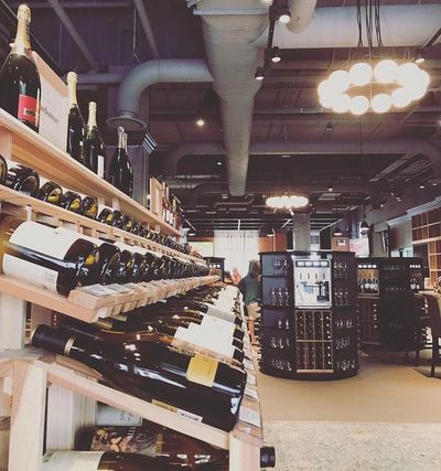 A rack of wines and a Napa Technology WineSation