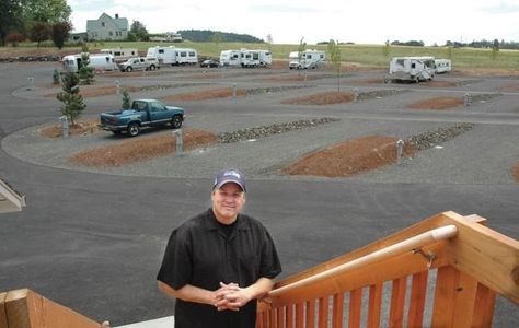 A man looking on the camera behind the car parking