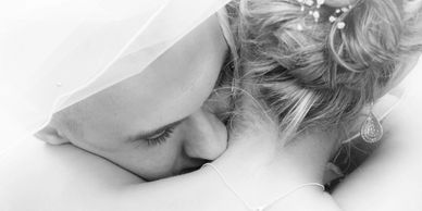 Romantic and sensual wedding photograph. Photography is black and white. Close up of brides neck wit