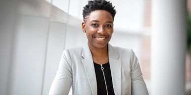 An African-American woman smiling and looking at camera professionally
