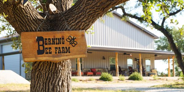 The Berning Bee Farm sign against the backdrop of the barn