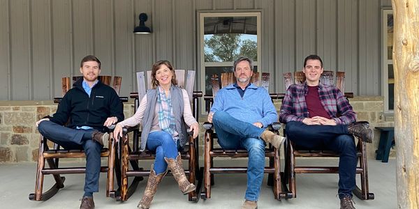 This is a family picture of the Bernings on the front porch in rocking chairs.