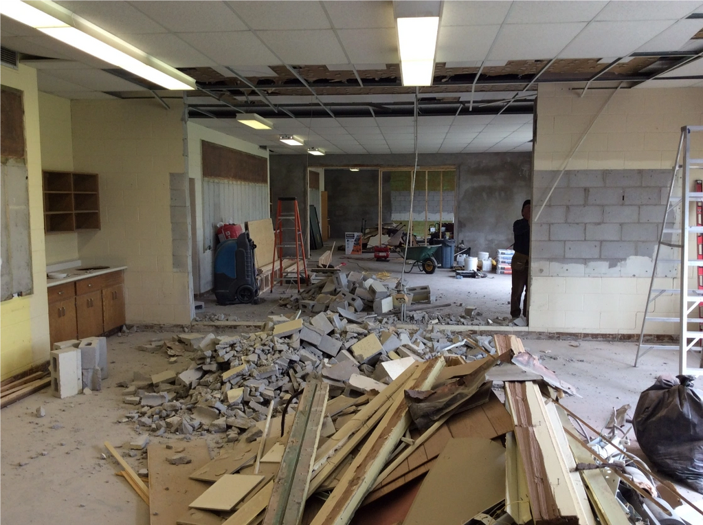 debris on floor after cutting holes in concrete walls