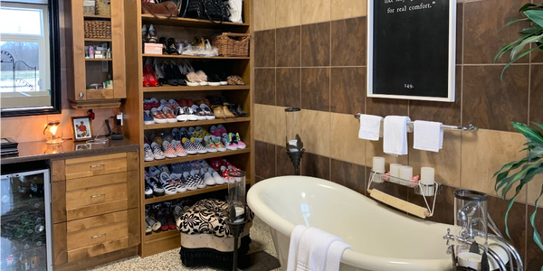 a shoe rack and slipper tube in a dressing room