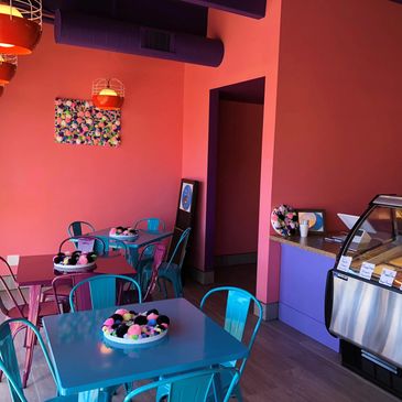 Walia Creamery's dining area with pink and purple walls, a sitting area, and the service counter