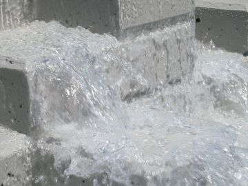 Water flowing over a cement waterfall that has been coated with an Urethane Coating.