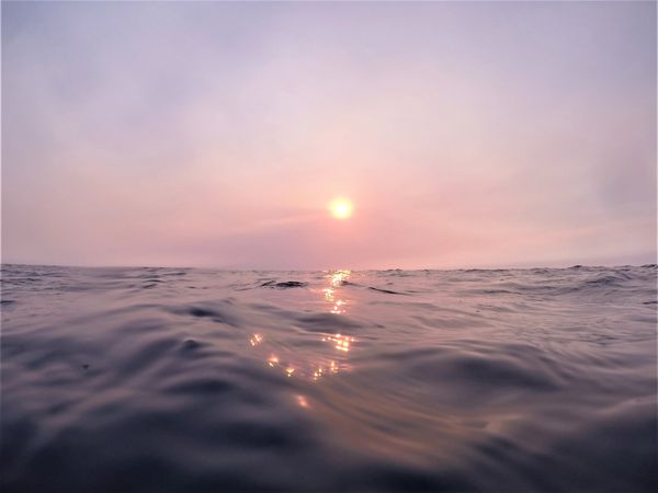 The Sun setting over Australia's Great Barrier Reef seen through the smoke haze of bushfires.