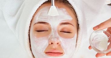 Woman receiving a spa facial to rejuvenate her skin and give her younger healthier skin.