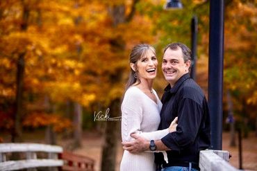 Couple sharing a moment together with the foliage behind them. 