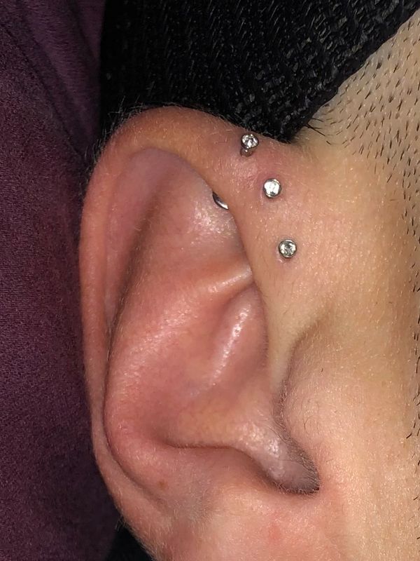 Triple Forward Helix ear piercing multiple piercings three piercings top of the ear piercing