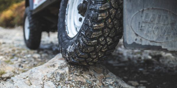Land rover defender off road tyre on rocky ground