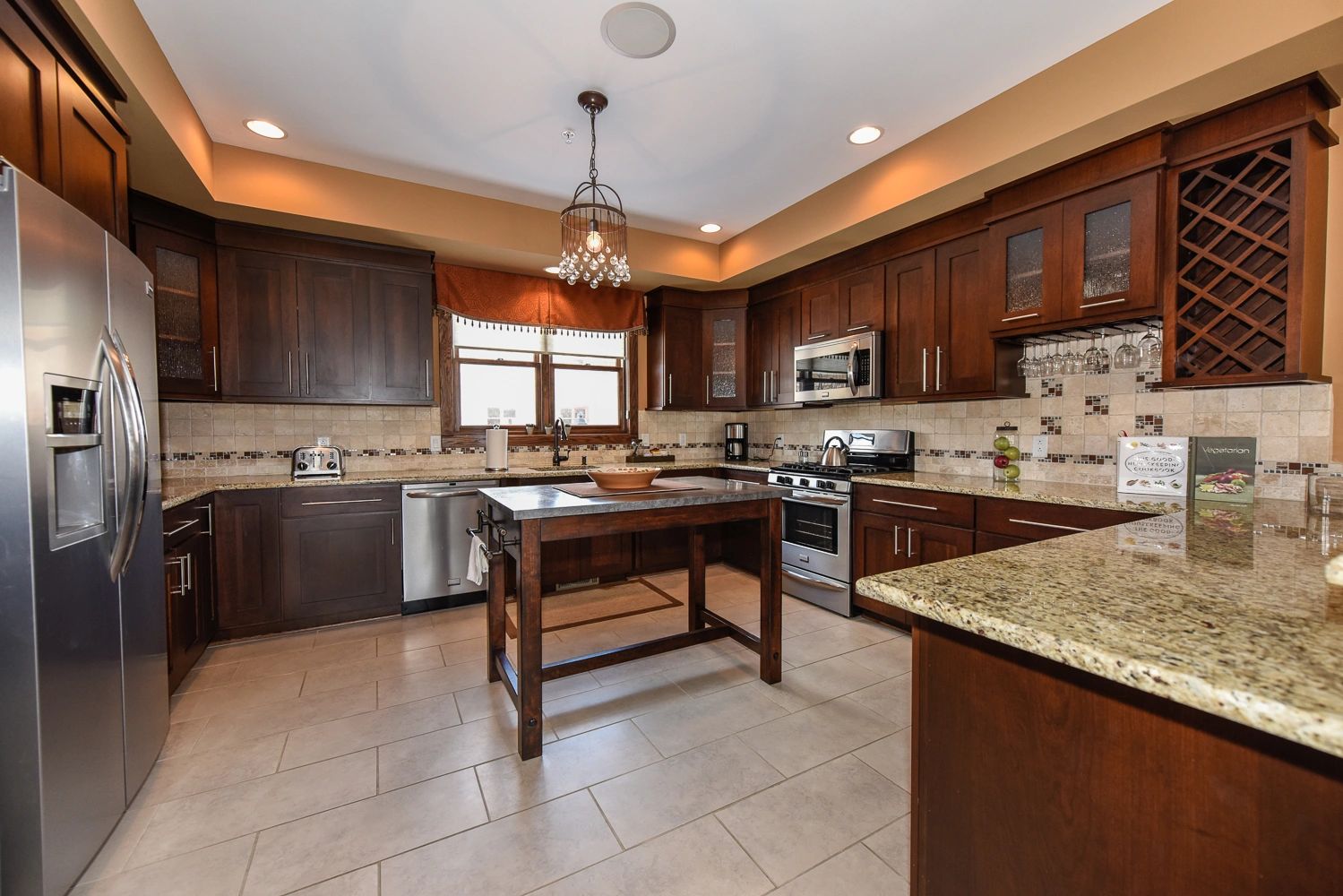 Kitchen with granite counter tops and stainless steel appliances.
