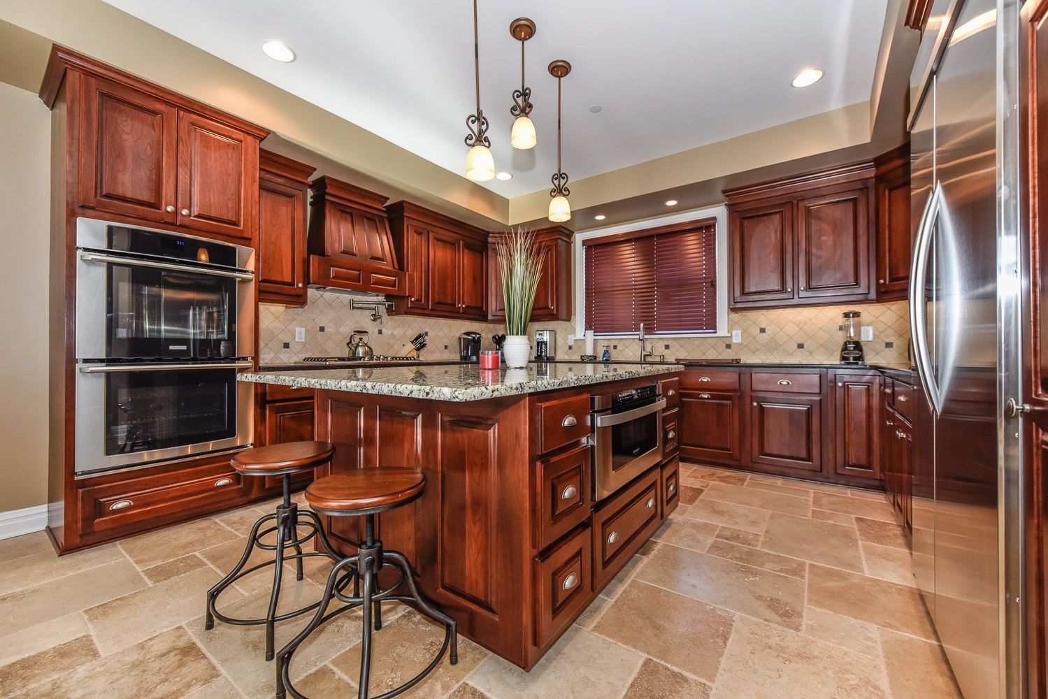 Kitchen with stainless steel appliances, custom cabinetry, granite counter tops.