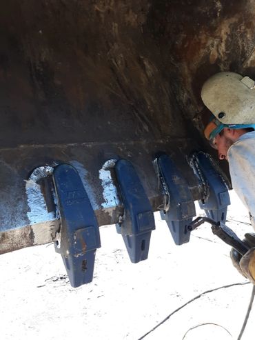 Bucket repair on heavy machinery