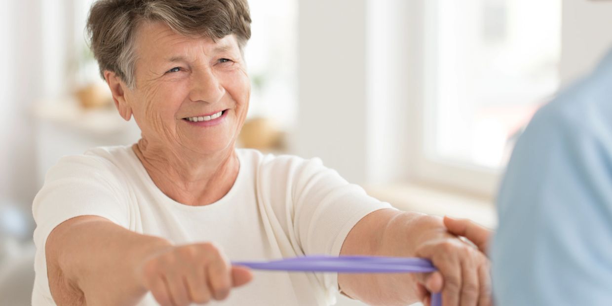 Older woman performing theraband exercises