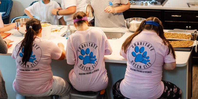 Small children baking inside a kitchen