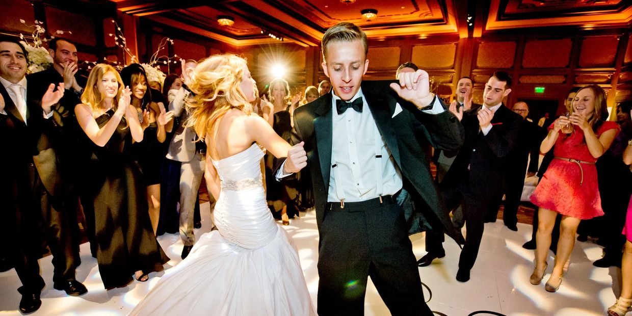 Guests and bride and groom dancing at reception wedding 