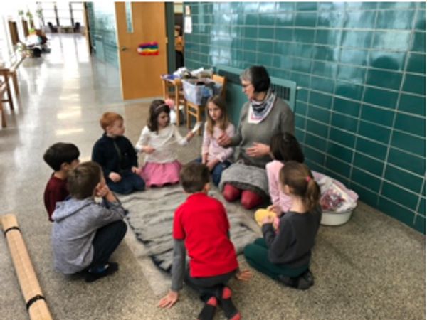 Collaborative wet felted rug project taught to 2nd graders